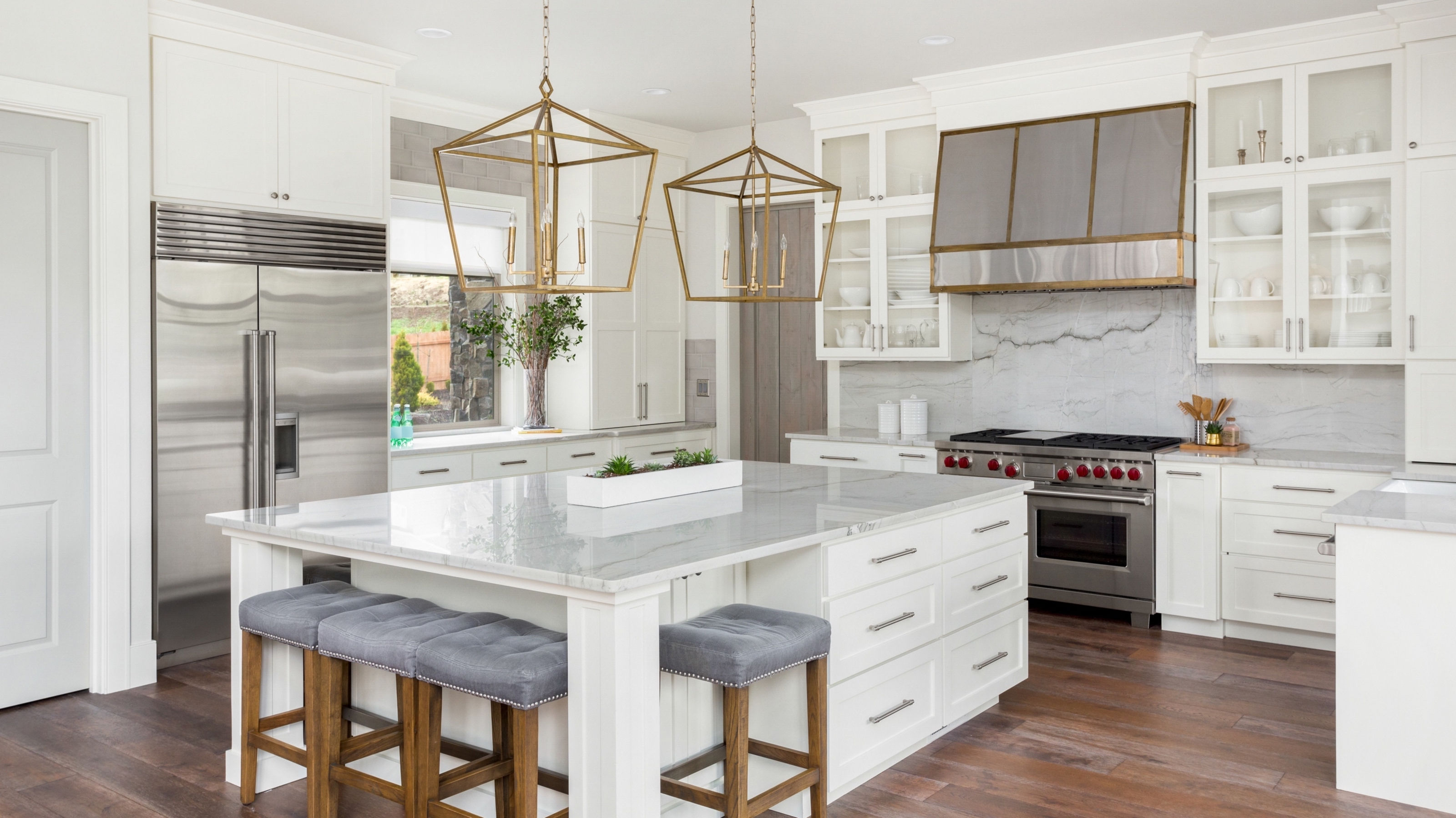 beautiful-kitchen-in-new-luxury-home-with-island,-pendant-lights,-and-hardwood-floors