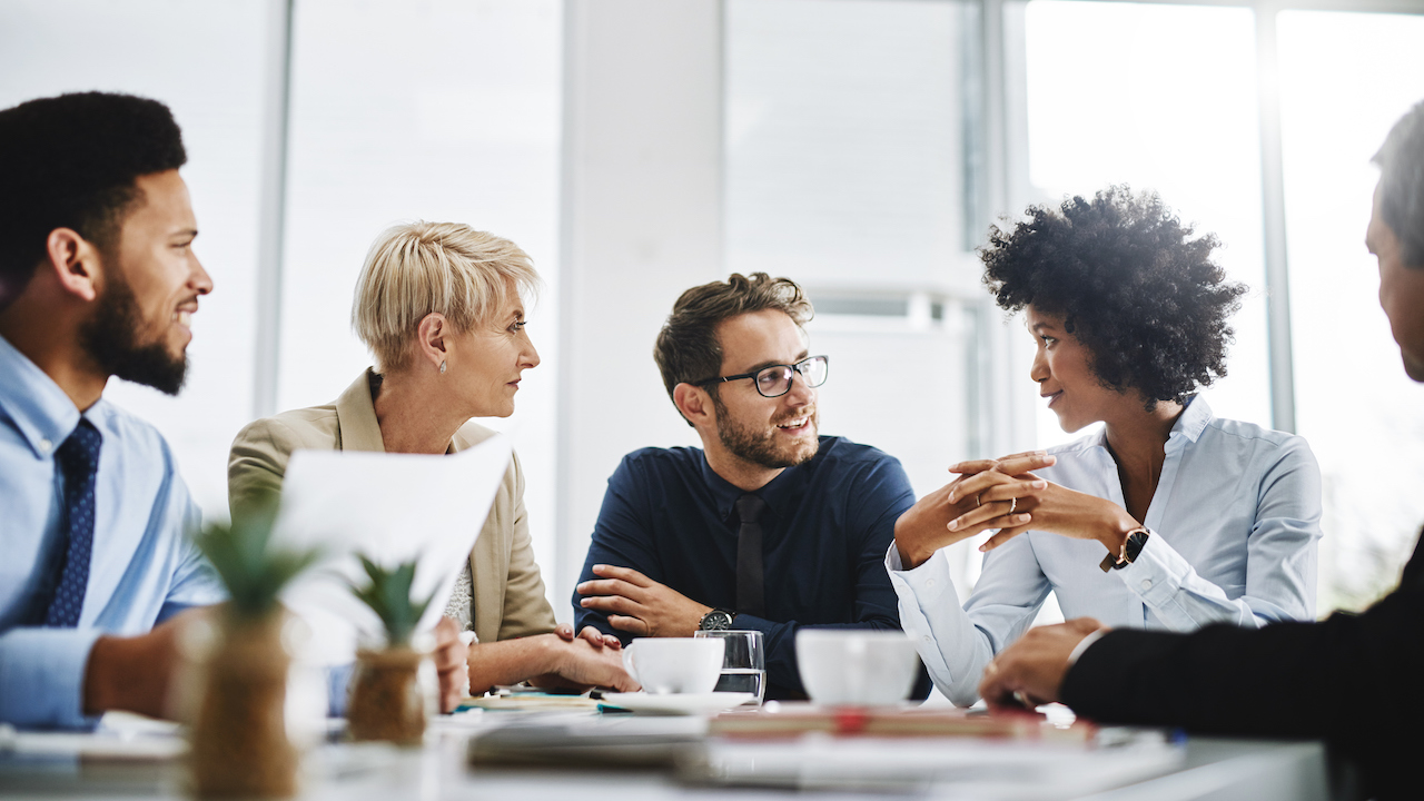 Search Now Cropped shot of a diverse group of businesspeople sitting together and having a meeting in the office
